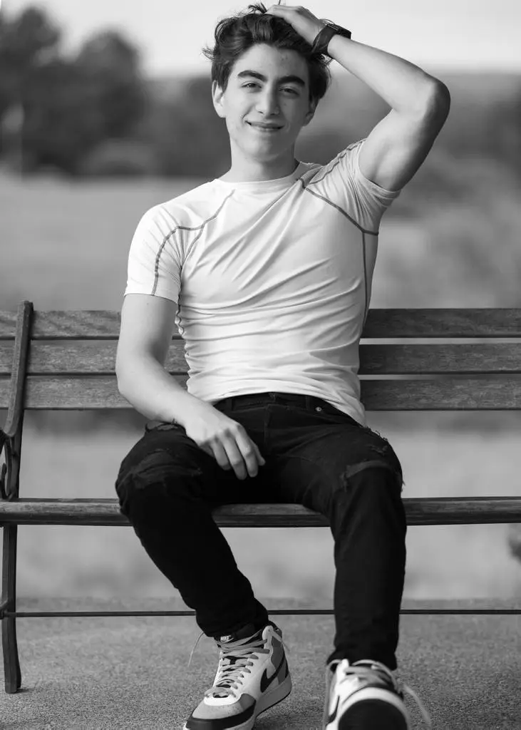 Confident senior standing with a bold expression in grayscale