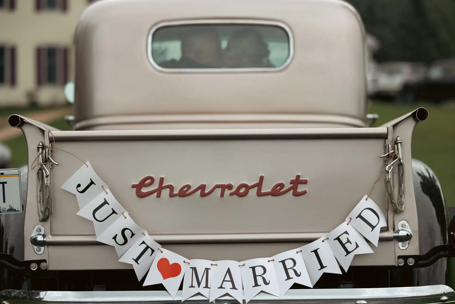 Chevrolet truck with "Just Married" banner, symbolizing celebration and love on a wedding day, capturing the joy and essence of a memorable wedding experience.