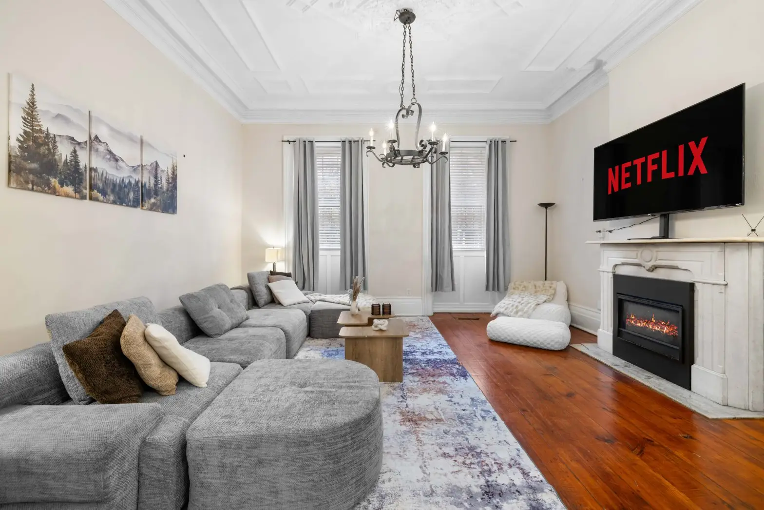Airbnb living room photography showcasing staged seating, fireplace, and entertainment area in Buffalo NY by John Angelo Photography